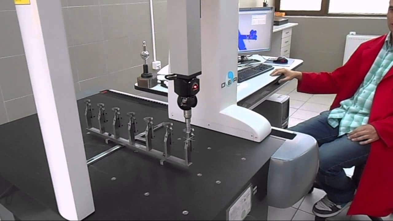 CMM coordinate measuring machine inspecting a precision machined part