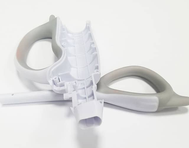 Precision overmolded medical device handles with soft grip surface for comfort and clinical performance